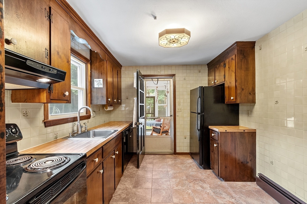 6 Ingalls Road Tyngsborough, MA 01879 - Photo 8 of 38 a kitchen with refrigerator and window