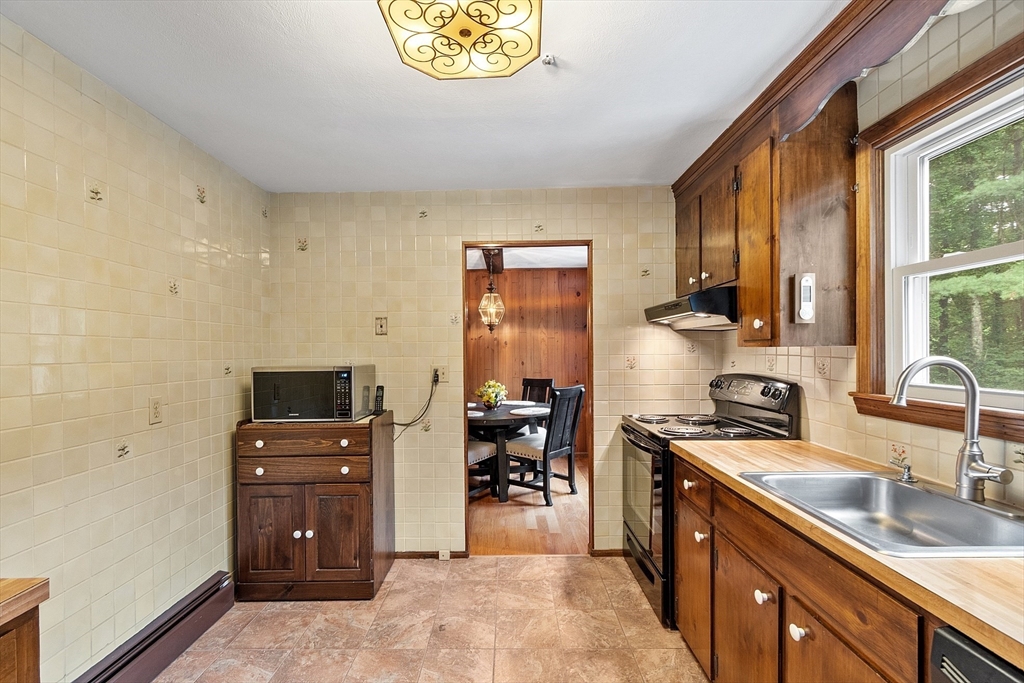 6 Ingalls Road Tyngsborough, MA 01879 - Photo 9 of 38 a kitchen with stainless steel appliances a sink stove and cabinets