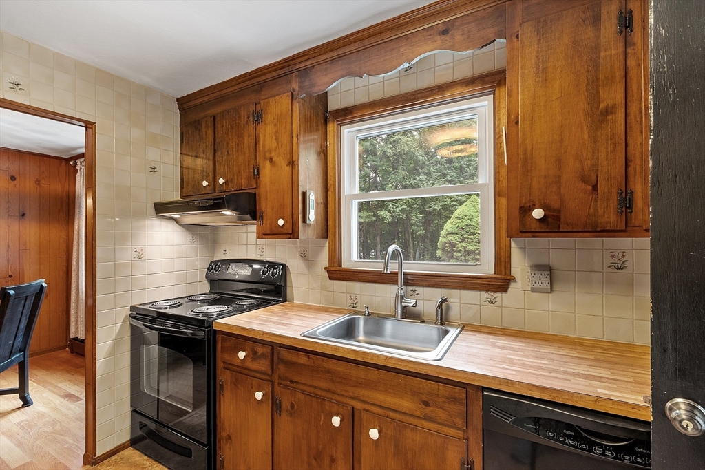 6 Ingalls Road Tyngsborough, MA 01879 - Photo 10 of 38 a kitchen with a sink stove and cabinets