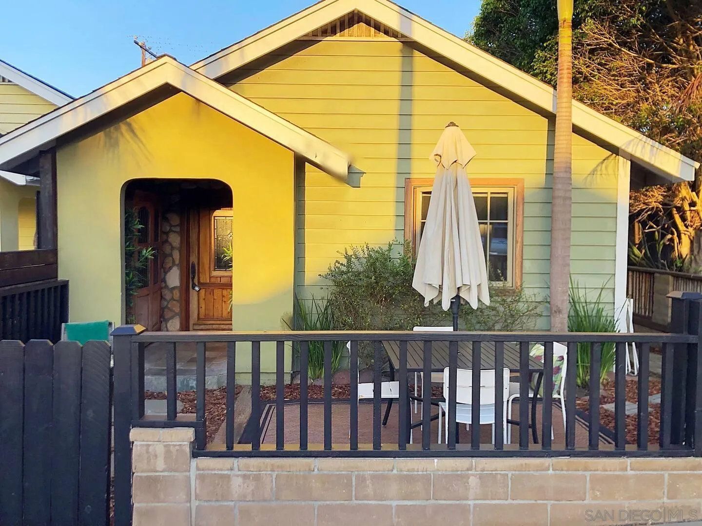 513 3rd Street Encinitas, CA 92024 - Photo 1 of 22 a view of a large building with a small yard and wooden fence