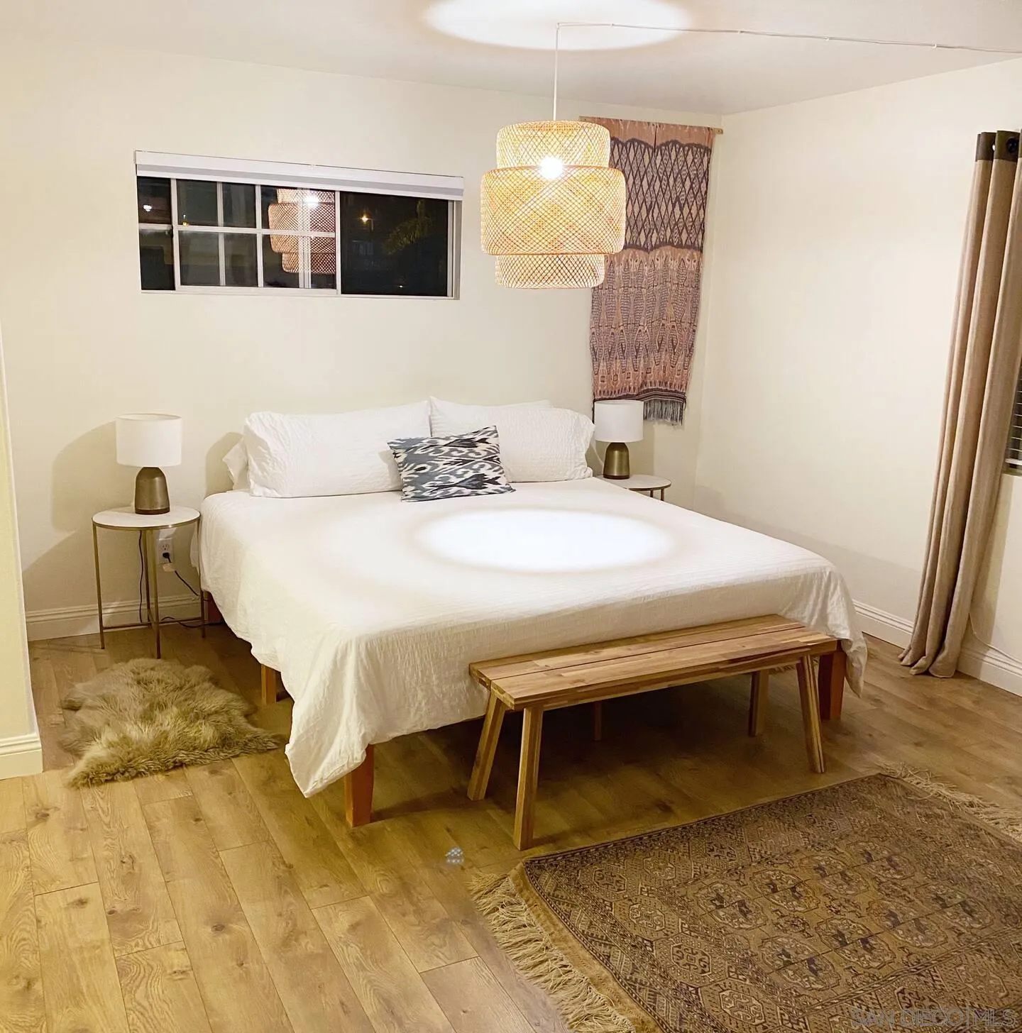 513 3rd Street Encinitas, CA 92024 - Photo 11 of 22 a bedroom with a bed and wooden floor