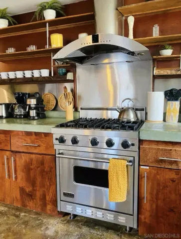 a stove top oven sitting inside of a kitchen