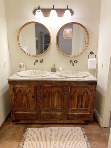 a bathroom with 2 sink and a mirror