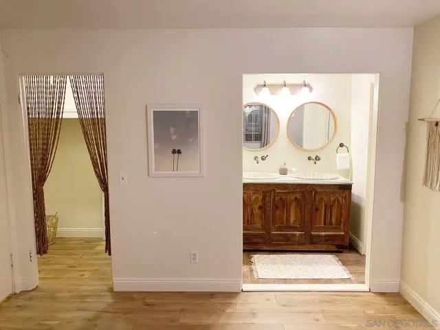 a bathroom with a sink a mirror and vanity