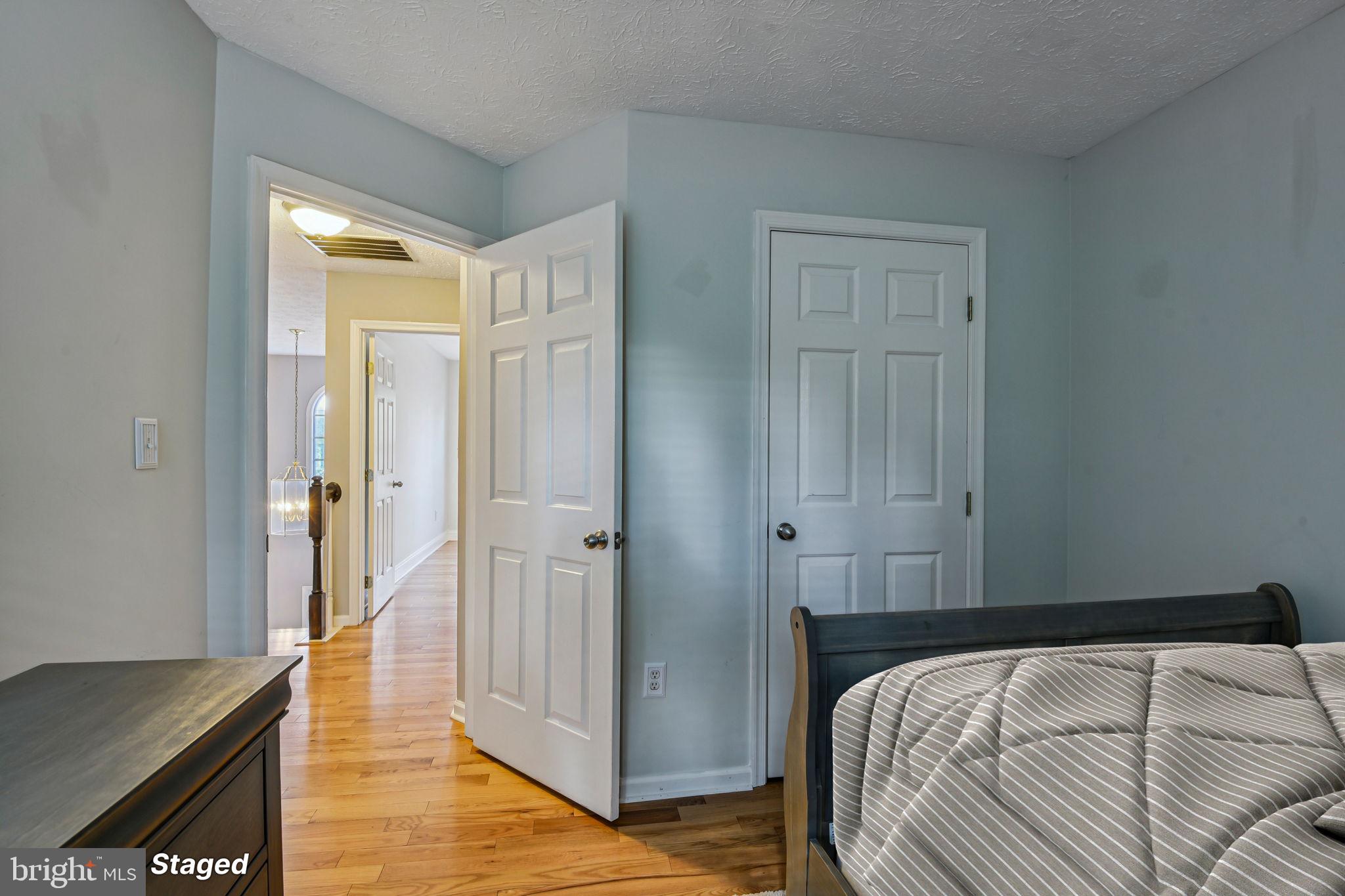 7617 Bear Forest Road Hanover, MD 21076 - Photo 22 of 37 a bedroom with a bed and wooden floor