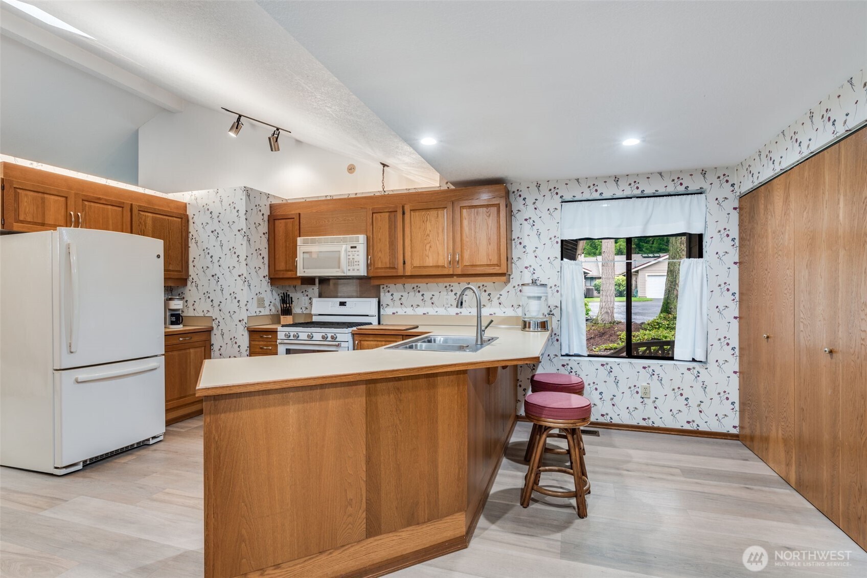 1322 Boise Street Fircrest, WA 98466 - Photo 11 of 40 a kitchen with stainless steel appliances a refrigerator and a stove top oven