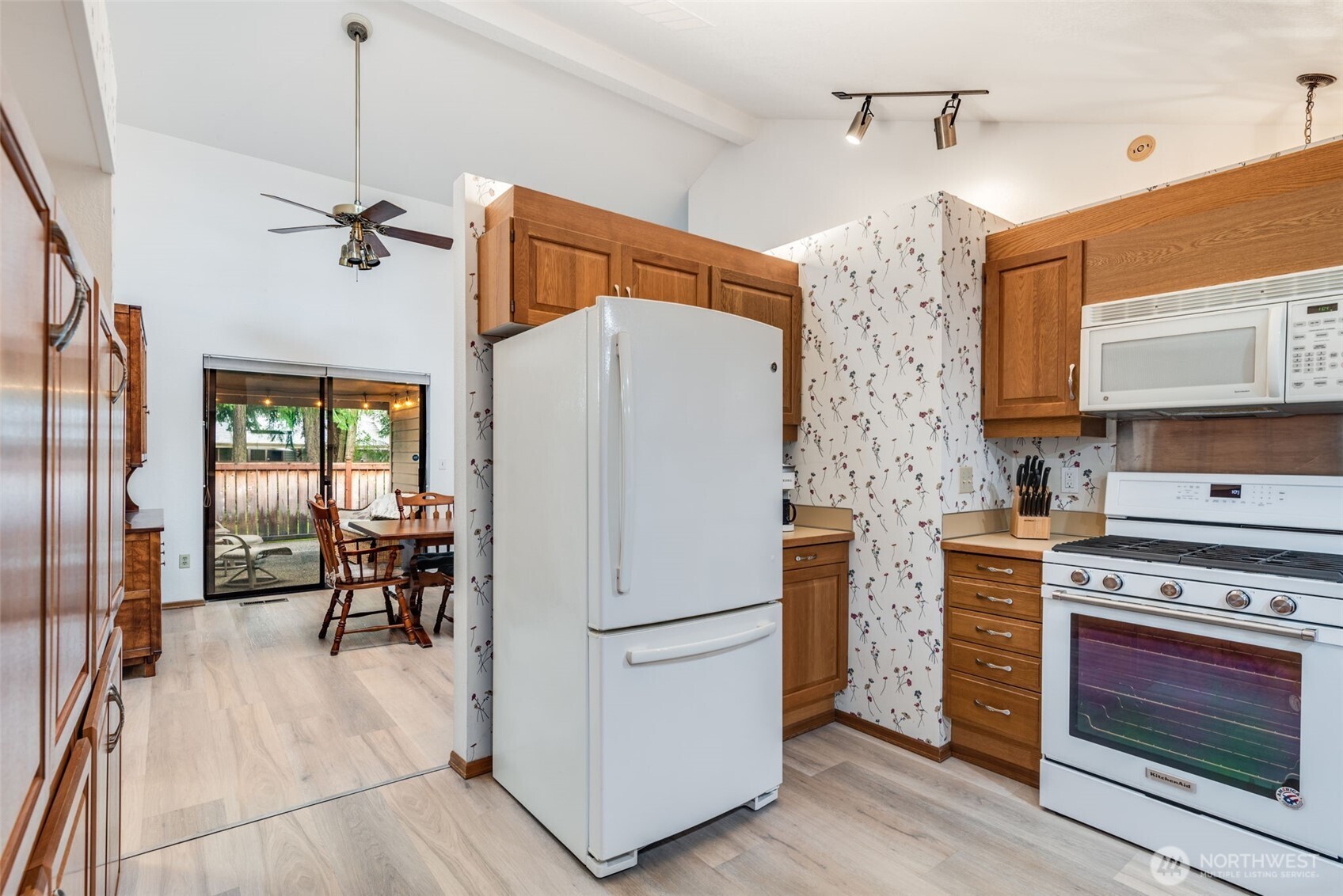 1322 Boise Street Fircrest, WA 98466 - Photo 15 of 40 a kitchen with stainless steel appliances a stove a refrigerator and a fireplace