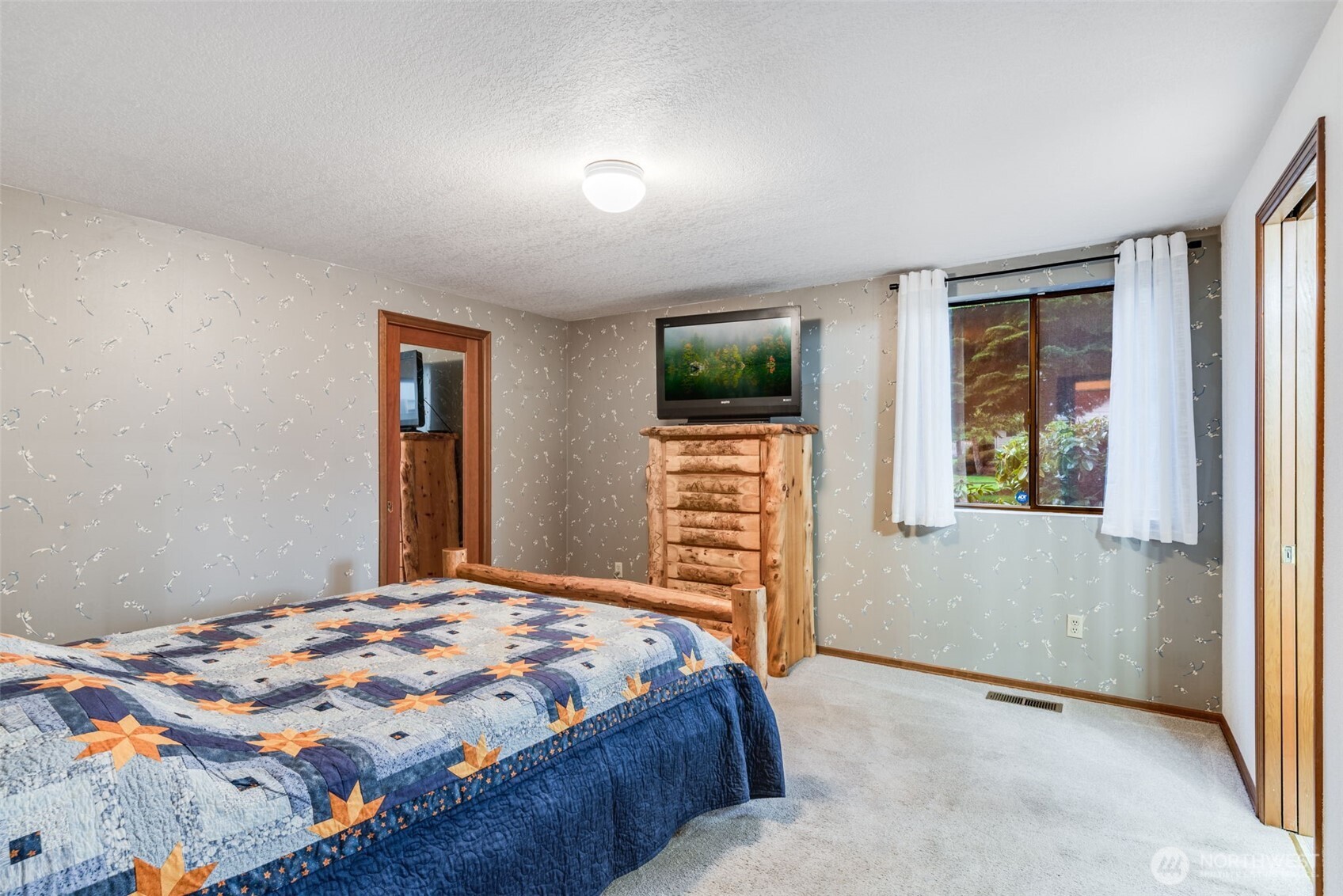 1322 Boise Street Fircrest, WA 98466 - Photo 22 of 40 a bedroom with a bed and a flat screen tv