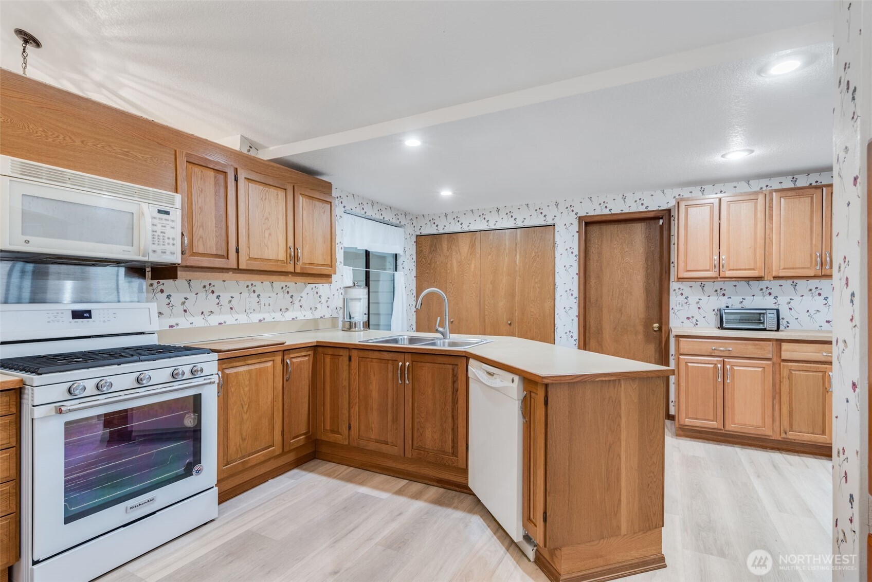 1322 Boise Street Fircrest, WA 98466 - Photo 9 of 40 a kitchen with stainless steel appliances granite countertop a stove and a sink