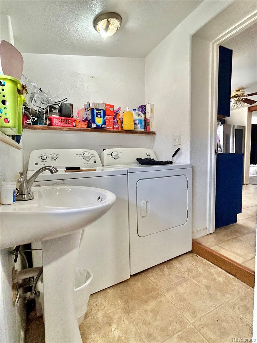 26 West 3rd Street Walsenburg, CO 81089 - Photo 12 of 27 a utility room with sink dryer and washer