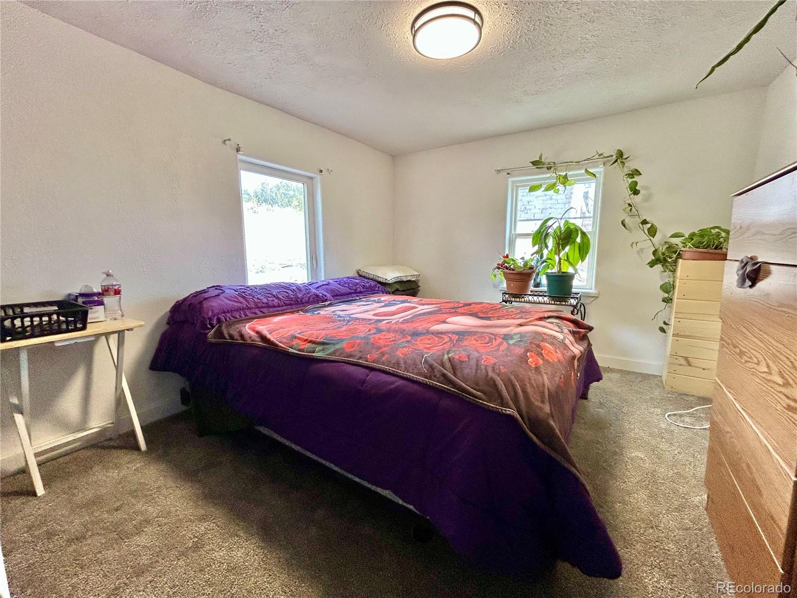 26 West 3rd Street Walsenburg, CO 81089 - Photo 13 of 27 a bed sitting in a bedroom next to a window