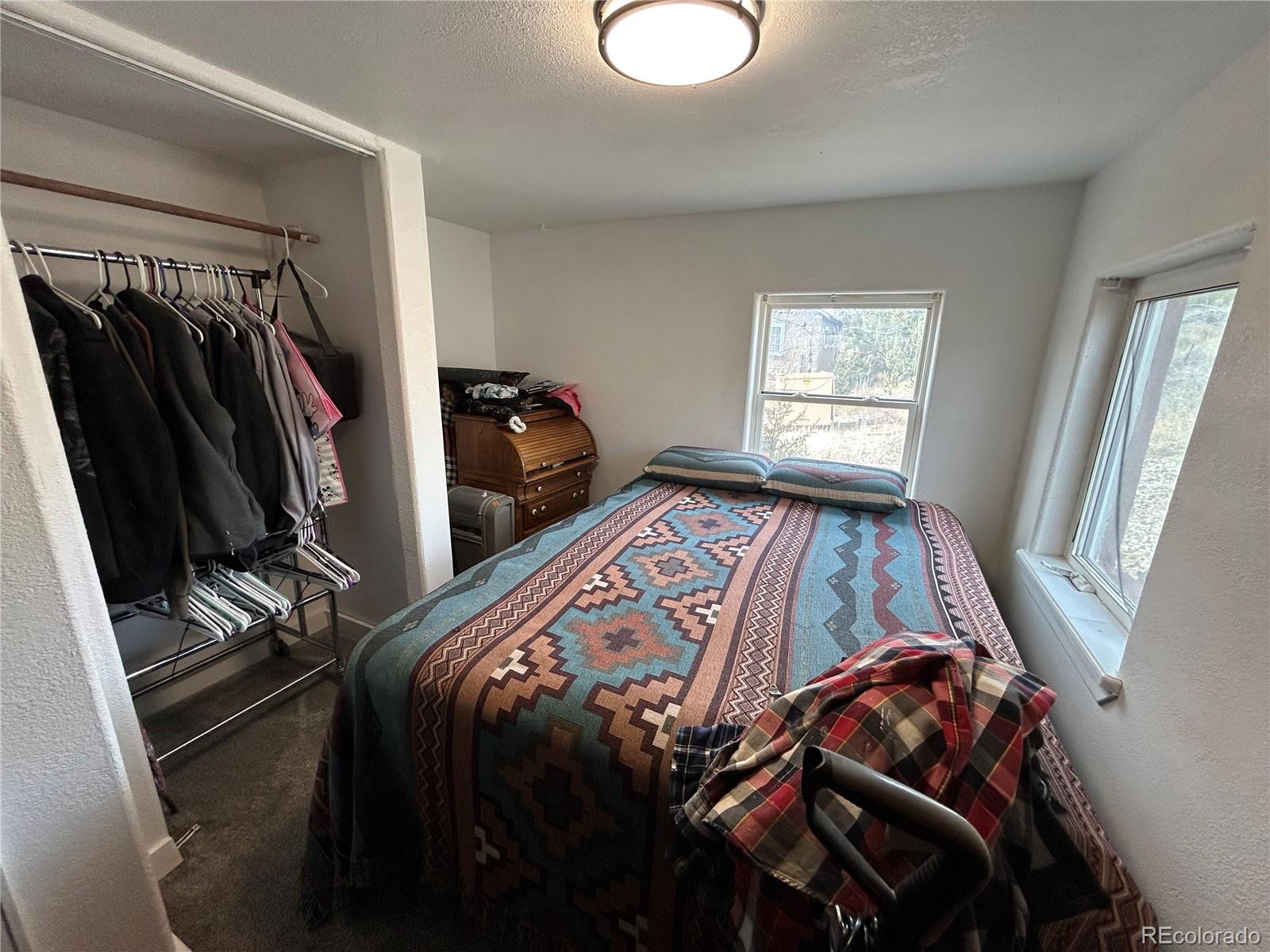 26 West 3rd Street Walsenburg, CO 81089 - Photo 14 of 27 a bed sitting in a bedroom next to a window