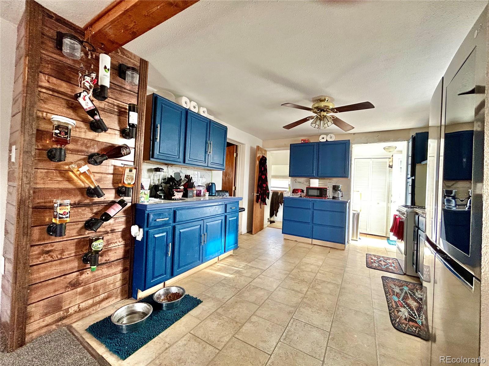 26 West 3rd Street Walsenburg, CO 81089 - Photo 5 of 27 a kitchen with stainless steel appliances kitchen island granite countertop a refrigerator and a stove top oven