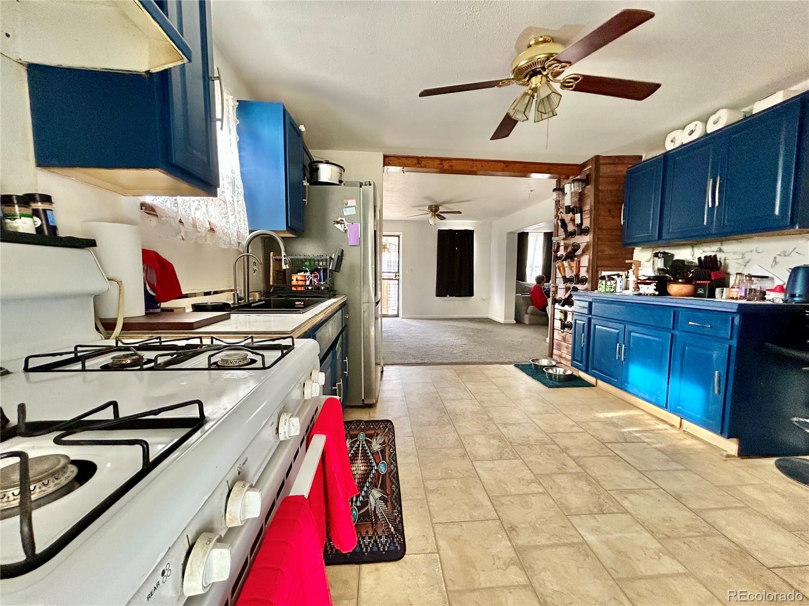 26 West 3rd Street Walsenburg, CO 81089 - Photo 7 of 27 a very nice looking kitchen with granite countertop a stove and a sink