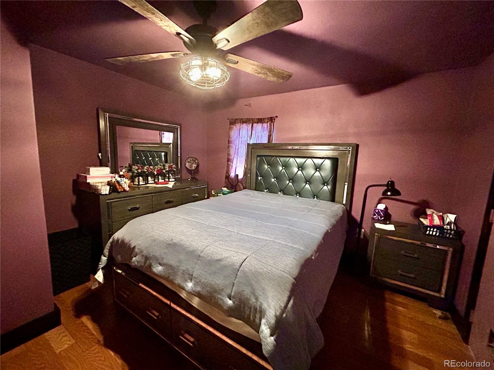 26 West 3rd Street Walsenburg, CO 81089 - Photo 10 of 27 a bedroom with a bed and lamp on dresser