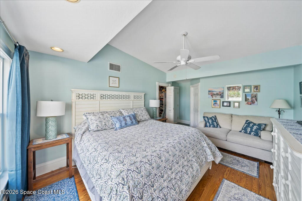 1110 Riverside Drive Titusville, FL 32780 - Photo 20 of 50 a bedroom with a bed a lamp and a dresser