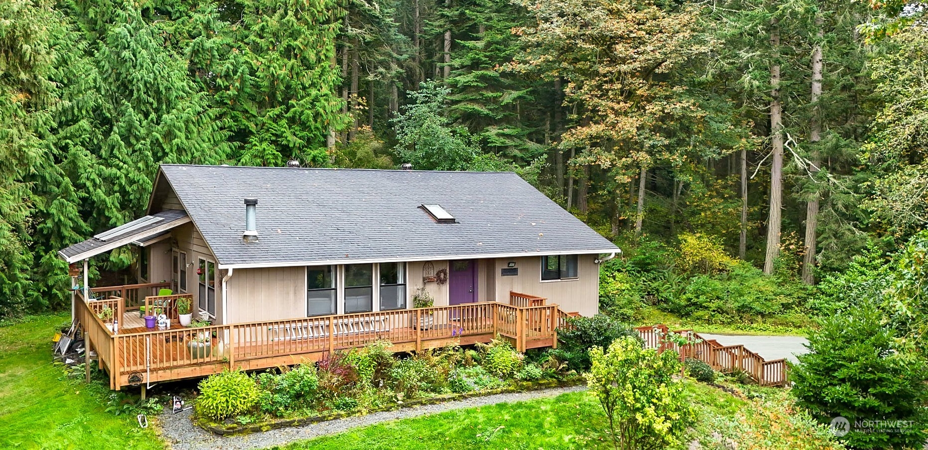 4848 Sharpe Road Anacortes, WA 98221 - Photo 1 of 33 a aerial view of a house with swimming pool next to a big yard