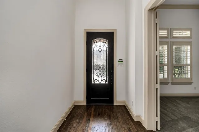 a view of an entryway with wooden floor