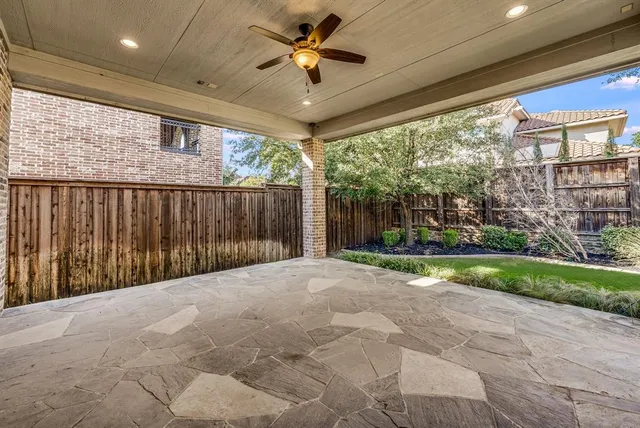 a view of a porch with furniture and floor to ceiling window
