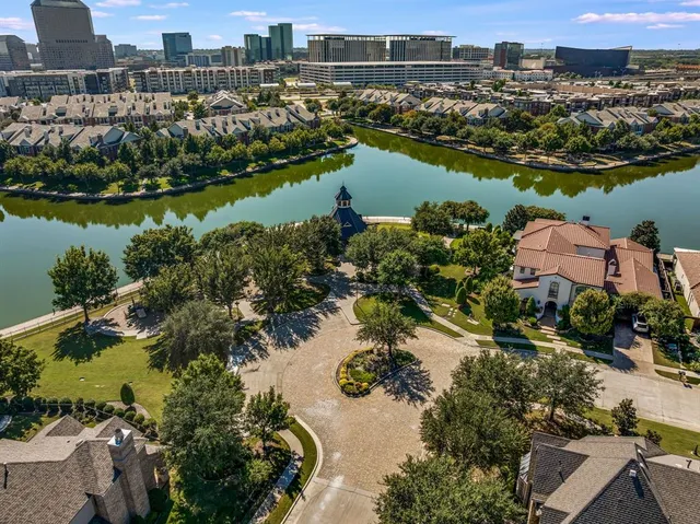 a view of a livingroom with a flat screen tv wooden floor and a ceiling fan