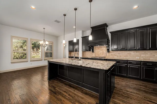a view of a livingroom with wooden floor and a large window