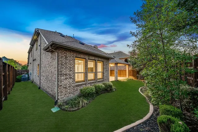 a view of a house with a small yard and a garden