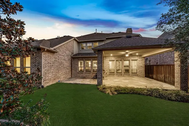 a view of a house with a yard and pathway