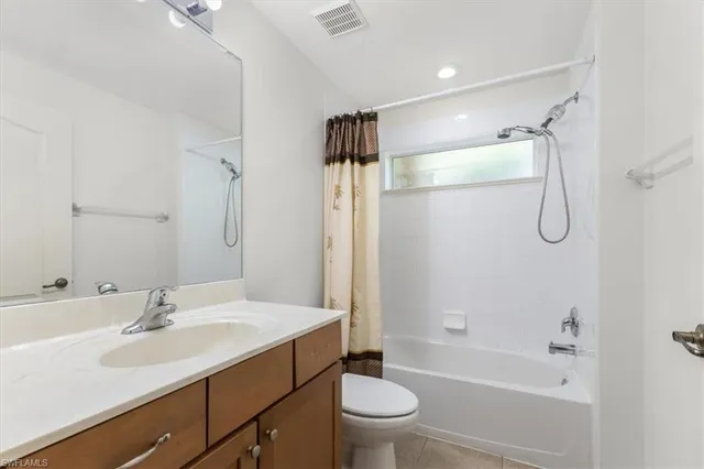 a bathroom with a sink toilet double vanity and shower