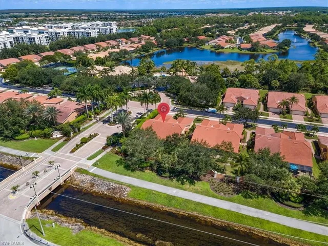 an aerial view of a house with a garden and lake view
