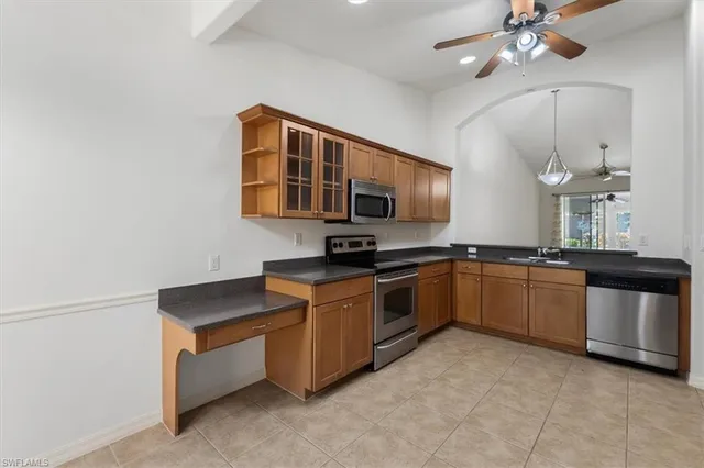 a kitchen with stainless steel appliances granite countertop a sink and a stove