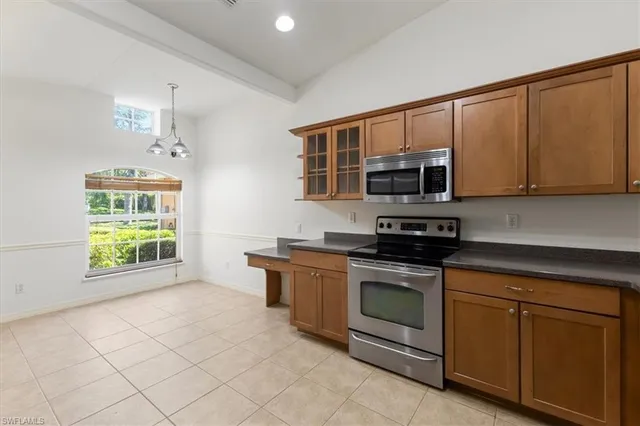a kitchen with stainless steel appliances granite countertop a stove a microwave and a sink