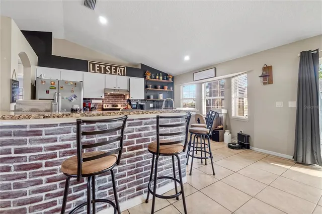 a kitchen with stainless steel appliances kitchen island granite countertop a sink and cabinets