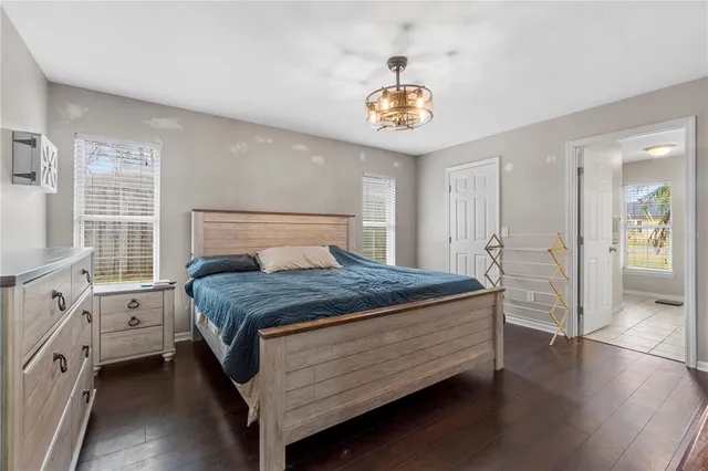 a bedroom with a bed and a chandelier