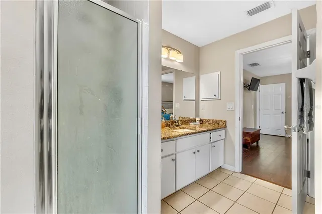 a view of a kitchen with a refrigerator and a sink