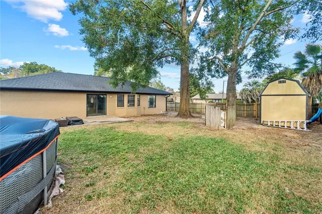 a backyard of a house with table and chairs