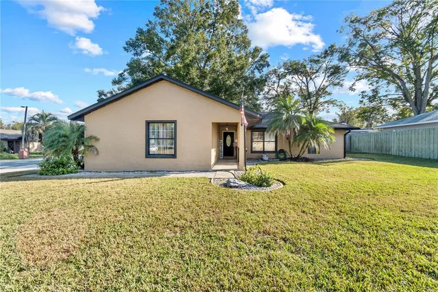 a view of a house with a yard and garage