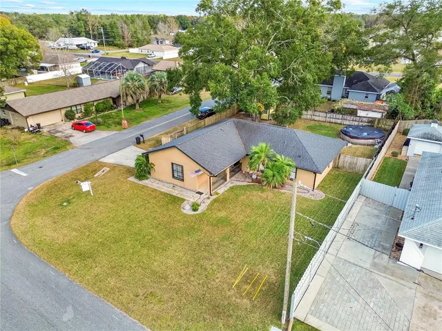 an aerial view of a house with a swimming pool