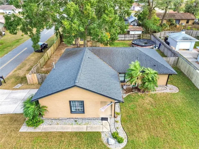 a view of a swimming pool with an outdoor seating and a yard