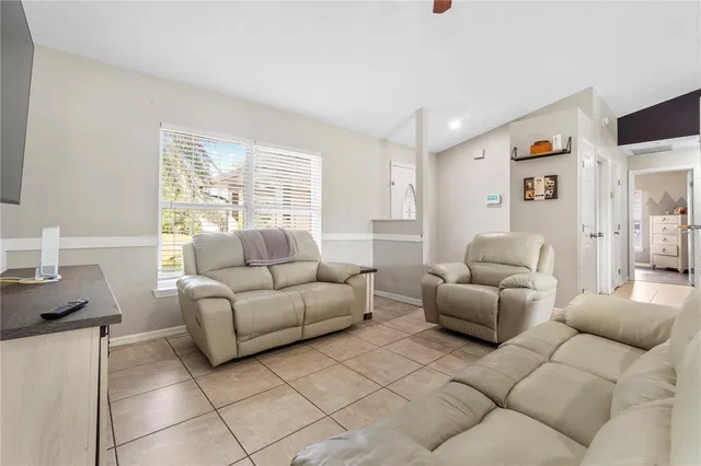 a living room with furniture and a large window