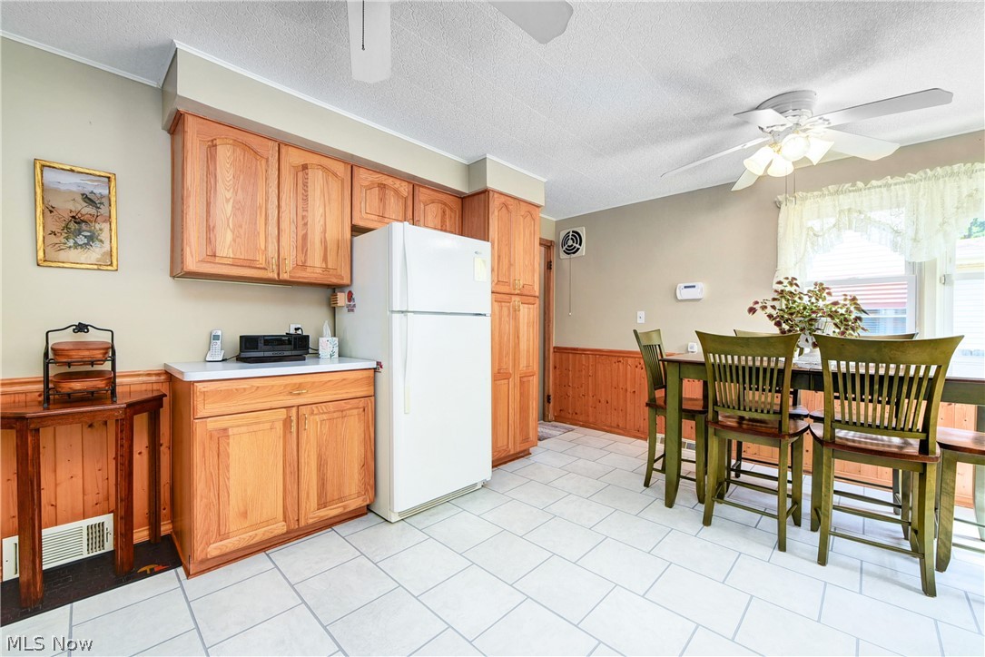 21399 Mastick Road Cleveland, OH 44126 - Photo 24 of 47 Kitchen featuring white refrigerator, a textured ceiling, ceiling fan, and light tile floors