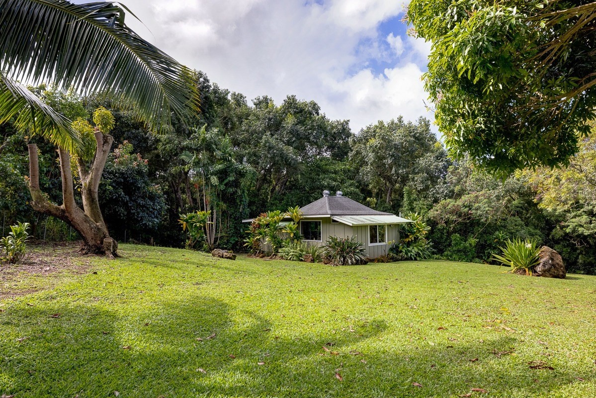 7475 E Koolau Road, Unit D Kilauea, HI 96754 - Photo 26 of 30 a view of a house with a yard