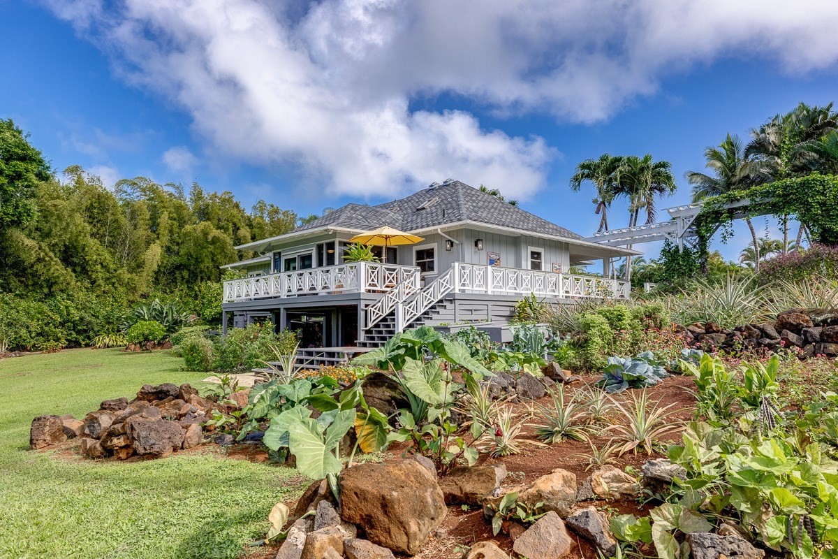 7475 E Koolau Road, Unit D Kilauea, HI 96754 - Photo 4 of 30 a front view of a house with a garden