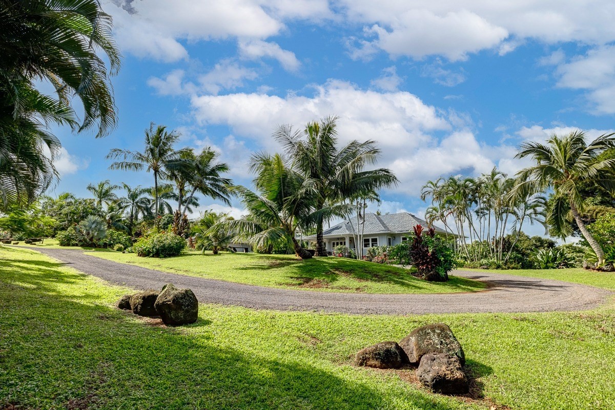 7475 E Koolau Road, Unit D Kilauea, HI 96754 - Photo 9 of 30 a view of a garden with a bench