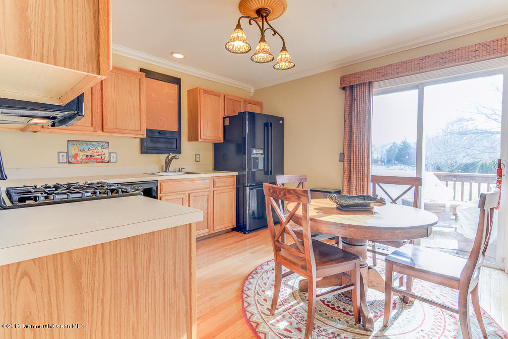 63 Racquet Road Wall, NJ 07719 - Photo 4 of 20 a dining room with a table chairs and a dining table