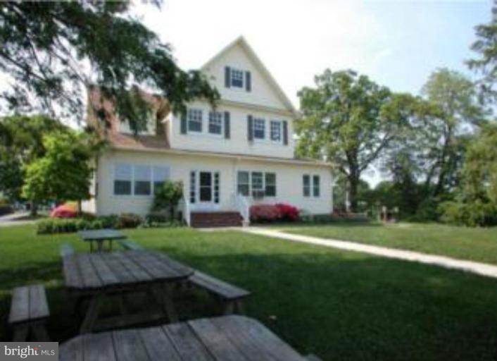 245 Providence Road Annapolis, MD 21409 - Photo 23 of 27 a front view of a house with a garden and trees