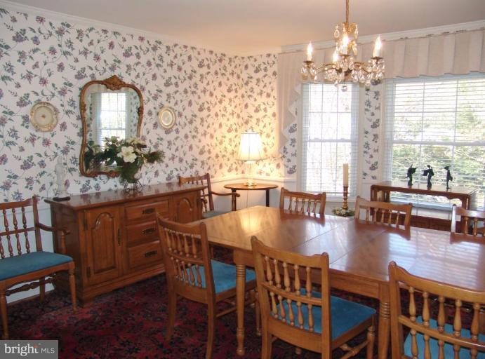 245 Providence Road Annapolis, MD 21409 - Photo 5 of 27 a dining room with furniture a chandelier and window