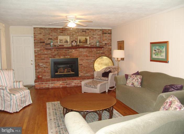 245 Providence Road Annapolis, MD 21409 - Photo 7 of 27 a living room with furniture and a fireplace