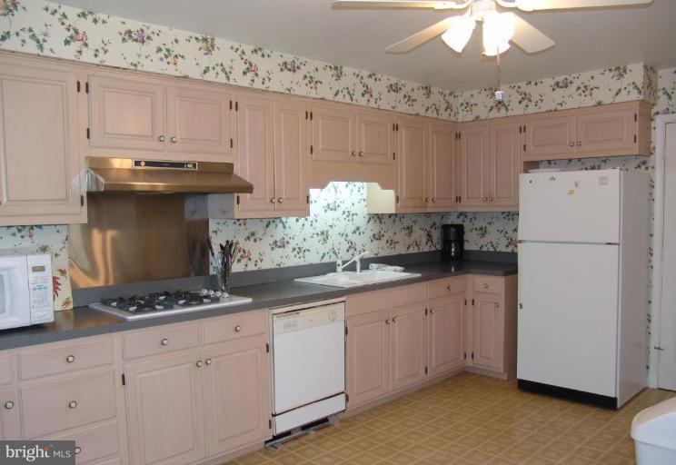 245 Providence Road Annapolis, MD 21409 - Photo 8 of 27 a kitchen with granite countertop a sink stainless steel appliances and cabinets