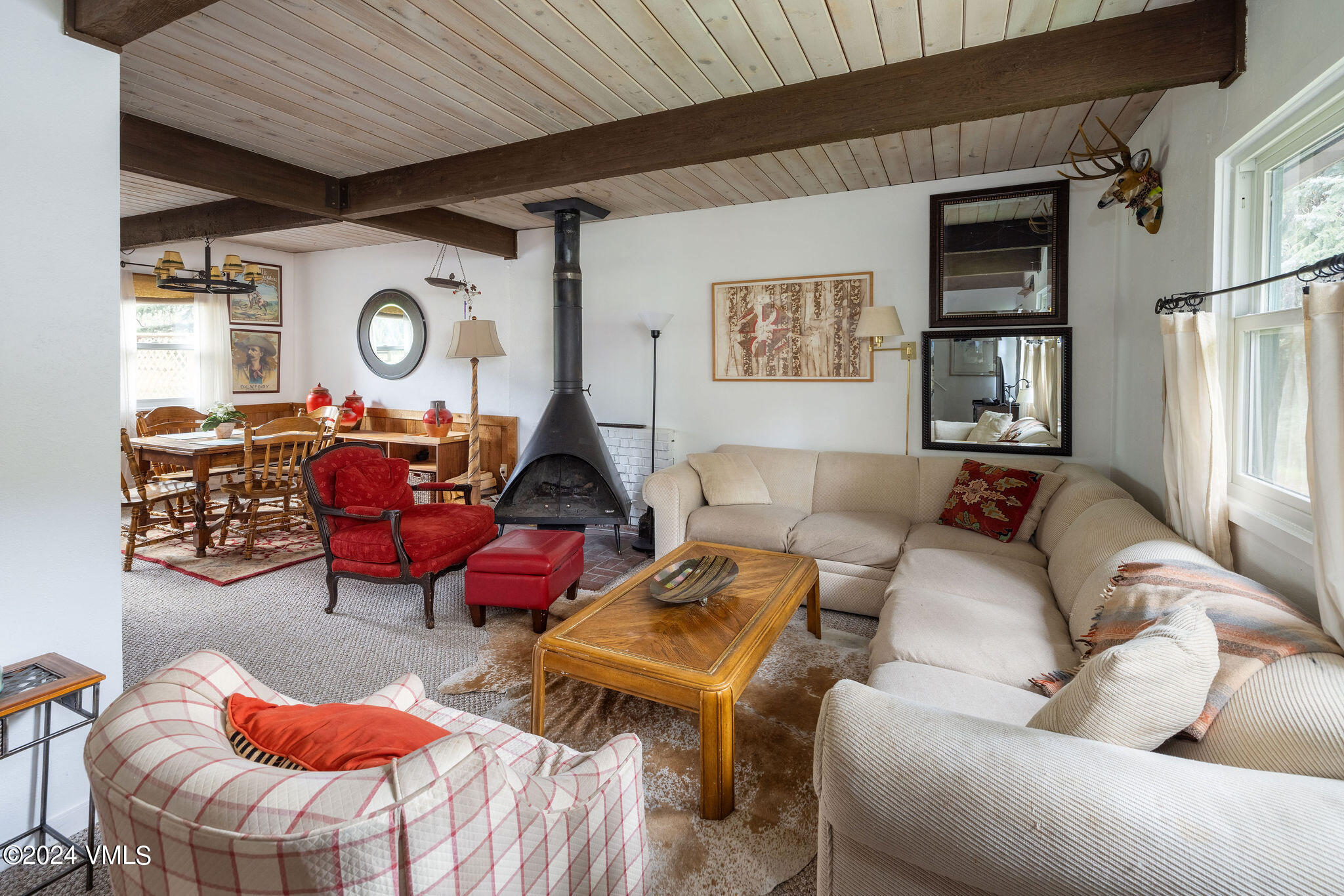 a living room with furniture a rug and a window