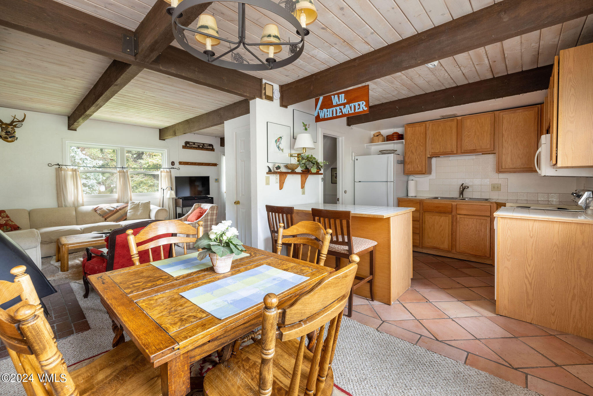 2456 Chamonix Lane, Unit B2 Vail, CO 81657 - Photo 6 of 18 a view of a dining room with furniture a kitchen and chandelier